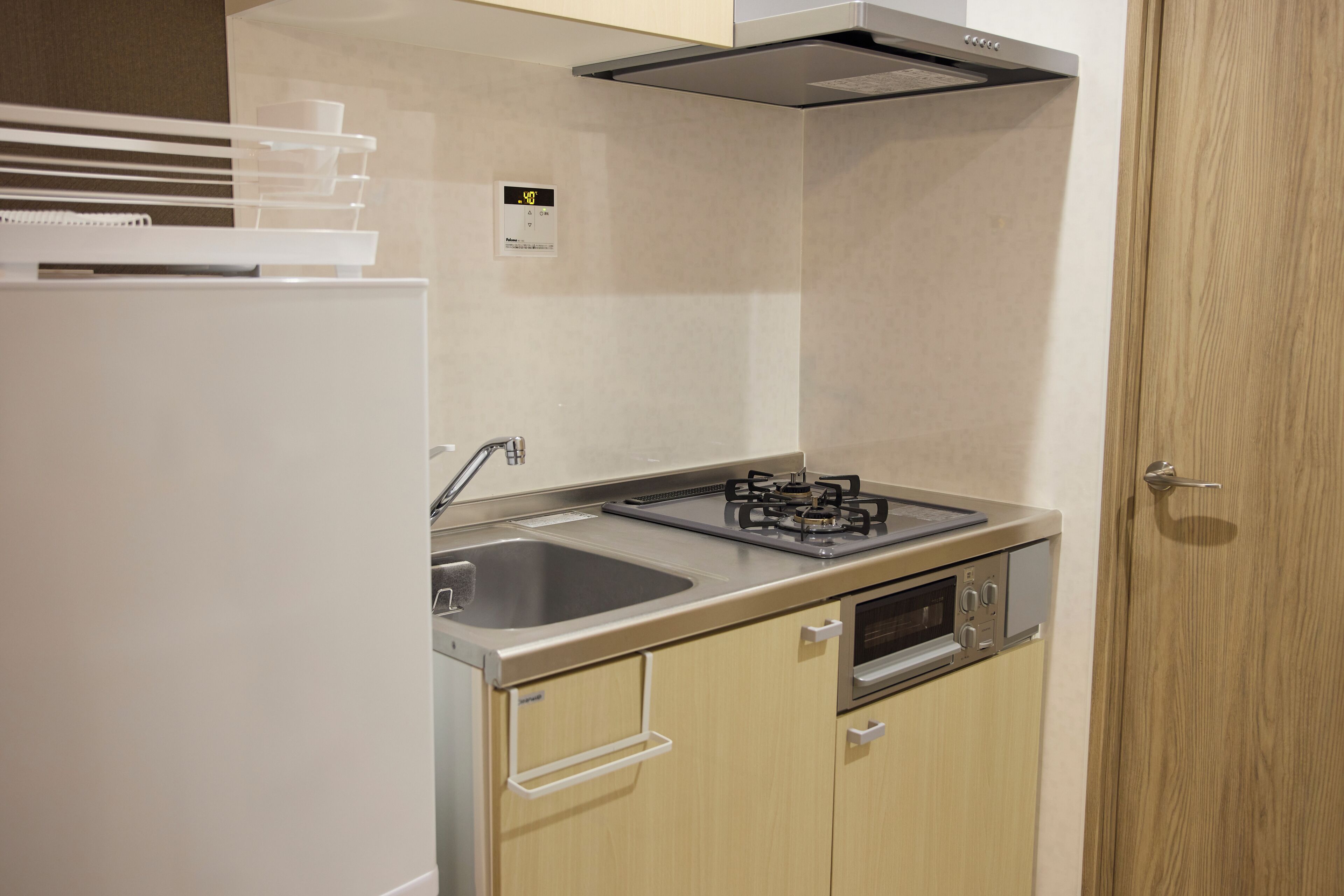 A compact kitchen with a gas stove, oven, and sink.