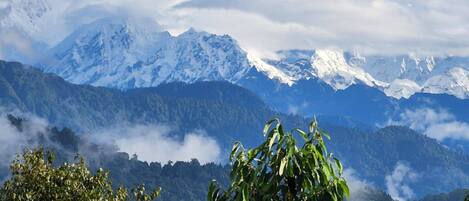 A mountain landscape with snow-capped peaks and lush green valleys.