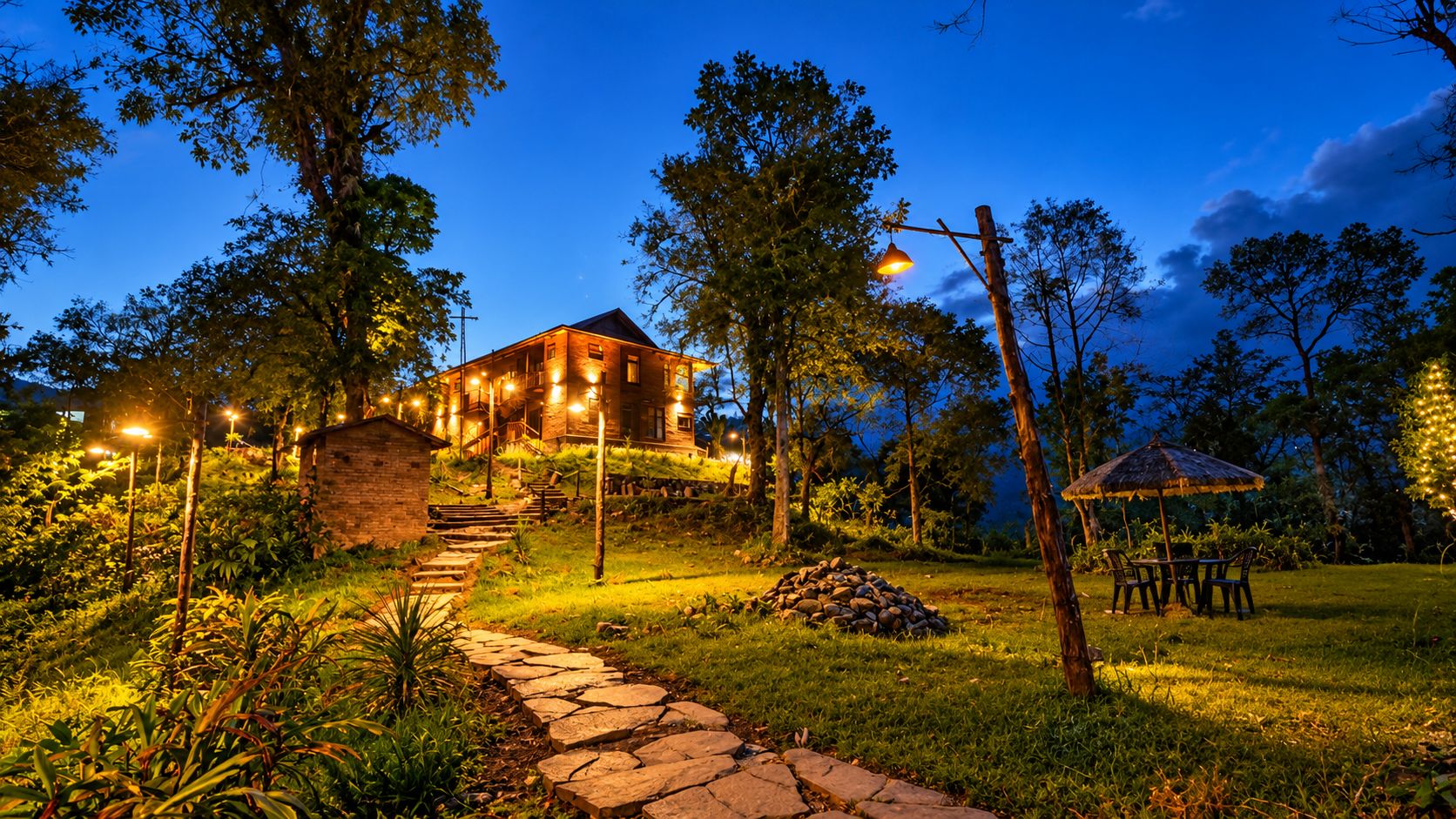 A house with a stone staircase leading up to it, surrounded by trees and a grassy area.