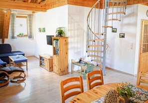 A modern interior with a spiral staircase, wooden furniture, and a cozy seating area. - Farmhouse 'Weißtanne' with Mountain View, Private Terrace and Wi-Fi (Oberkirch)