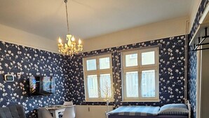 A bedroom with a bed, a desk, a chair, a TV, and a window. - Apartment 'Studio Zur »Alten Schmiede«' with Wi-Fi (Laage)