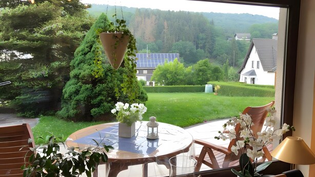 A round table with a potted plant, a white vase, and a lamp. - Apartment 'Poll' with Private Terrace, Private Garden and Wi-Fi (Wimbach)