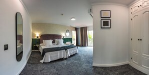 A hotel room with a large bed, a mirror, a wardrobe, and a view of the outdoors. - Hotel Tamisa (Mijas)