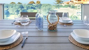 A table set for dining with a view of the sea and greenery. - Mare Azzurro by Interhome (Valledoria)