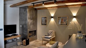 Uma sala de estar moderna com lareira, televisão e área de jantar.