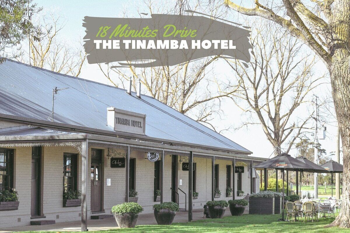 A two-story building with a sign reading "The Tinamba Hotel" at the entrance.