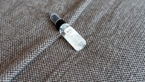 A bottle of sleep spray on a textured fabric surface. - Hybrid Resi - Mitcham | 2 Bed Apartment (Mitcham)