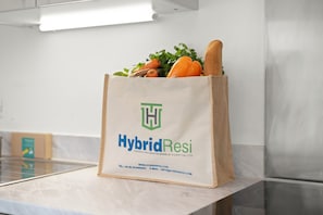A bag with 'HybridResi' branding, placed on a counter with a stainless steel appliance in the background.