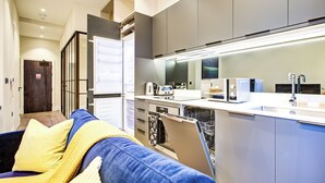 A modern kitchen with built-in appliances, a dishwasher, and a countertop.