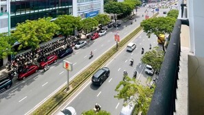 A city street with modern buildings, including a visible sign for 'Phi Long Technology'. - Mercury Apartment Danang (Da Nang)