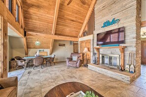 Cozy living space with a fireplace, flat-screen TV, and dining area.