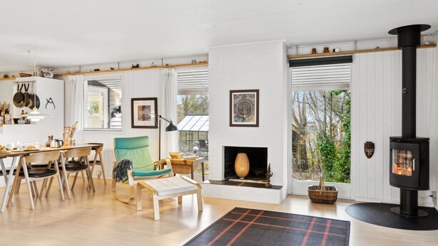 A modern living room with a fireplace, wooden furniture, and a large window. - "Henryette" - 1.5km from the sea by Interhome (Ebeltoft)