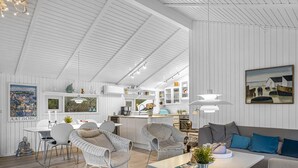 A spacious living area with a dining table, two sofas, and a kitchen in the background. - "Gonda" - 2km from the sea by Interhome (Saltum)