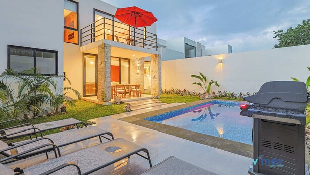 A modern outdoor pool area with a barbecue grill, lounge chairs, and a dining area with an umbrella. - Palmara Gated Community, Pool, Paddle Court & Gym (Playa del Carmen)