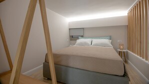 A bedroom with a bed, bedside table, and a window with wooden blinds. - Mylos 2 apt, Apartment (Agios Nikolaos)