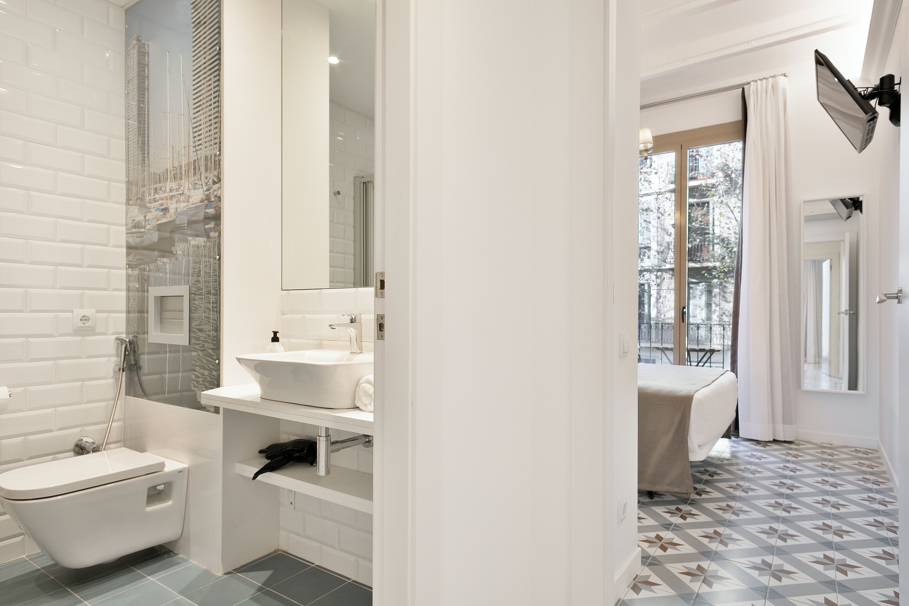 A modern bathroom with a freestanding bathtub, a vanity with a mirror, and a shower area.