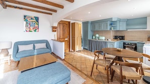 Una cucina moderna con mobili blu e un tavolo da pranzo in legno.