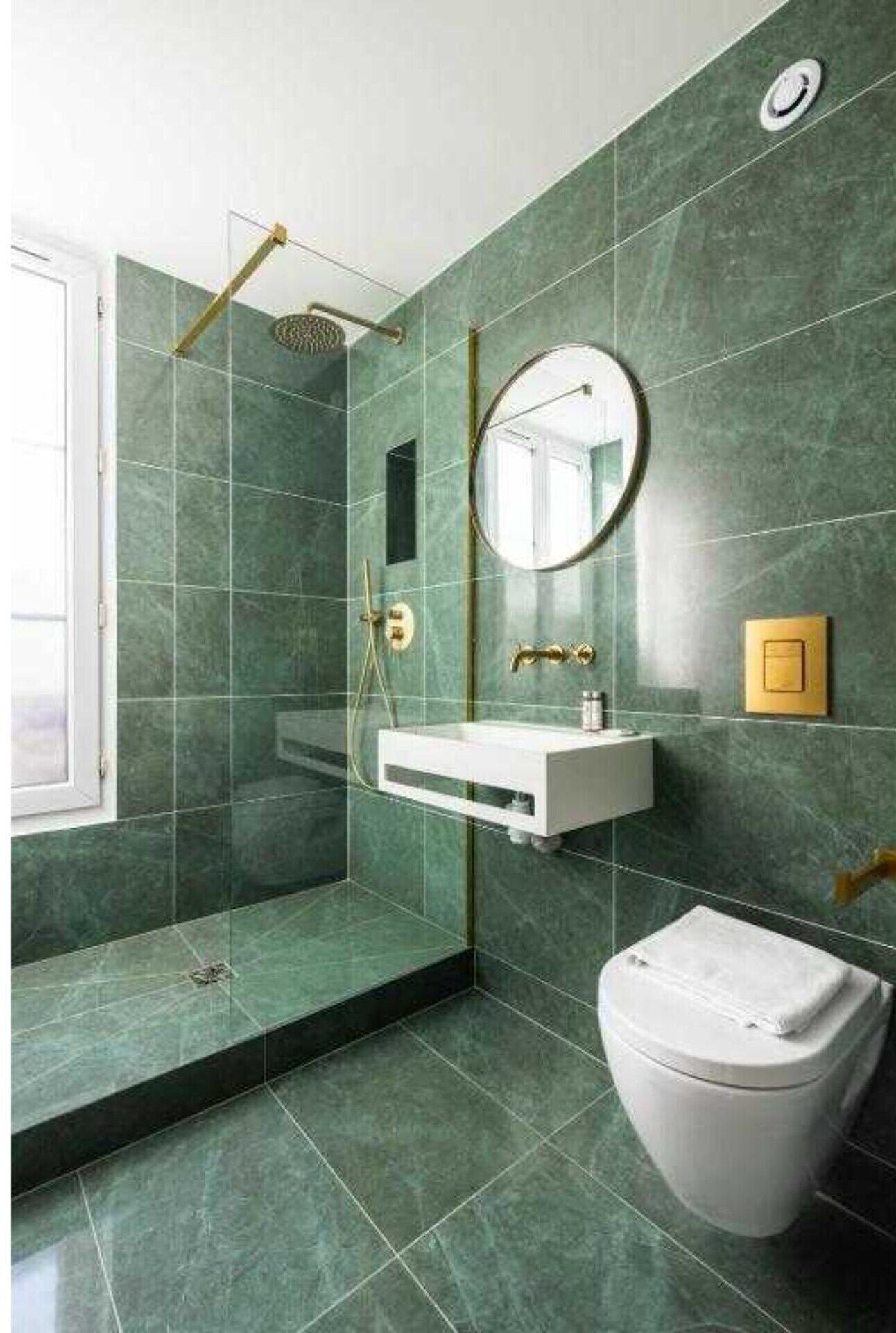 A bathroom with a shower, a sink, a toilet, and a mirror.
