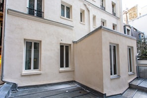 Stylish corner building with a flat roof and white-framed windows.