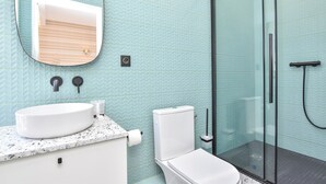 A bathroom with a white sink, toilet, and glass shower enclosure. - Charming Studio - 2P - Beaugrenelle / Eiffel Tower (Paris)