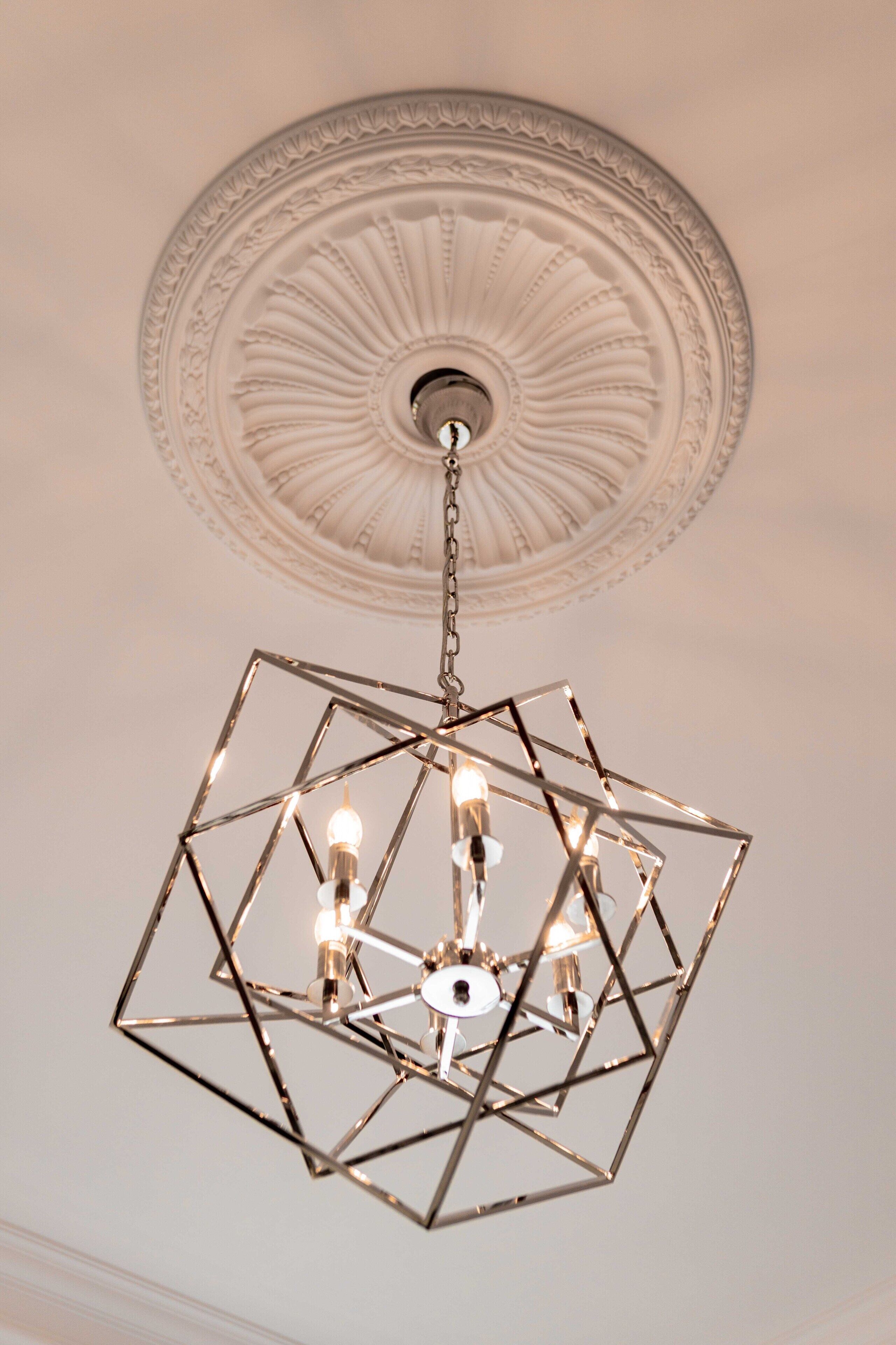 A geometric chandelier with multiple bulbs hanging from a chain.
