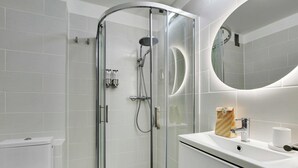 A modern bathroom with a glass-enclosed shower, a white sink, and a large mirror. - Modern "green Suites" Residence - Meudon/velizy (Meudon)