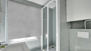 A bathroom with a shower, sink, and toilet. - Charming Studio for 2 People - Bastille (Paris)