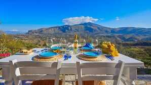 A table set for two with a mountain view in the background. - Villa Rosa dei Venti, Scopello (CASTELLAMMARE DEL GOLFO)