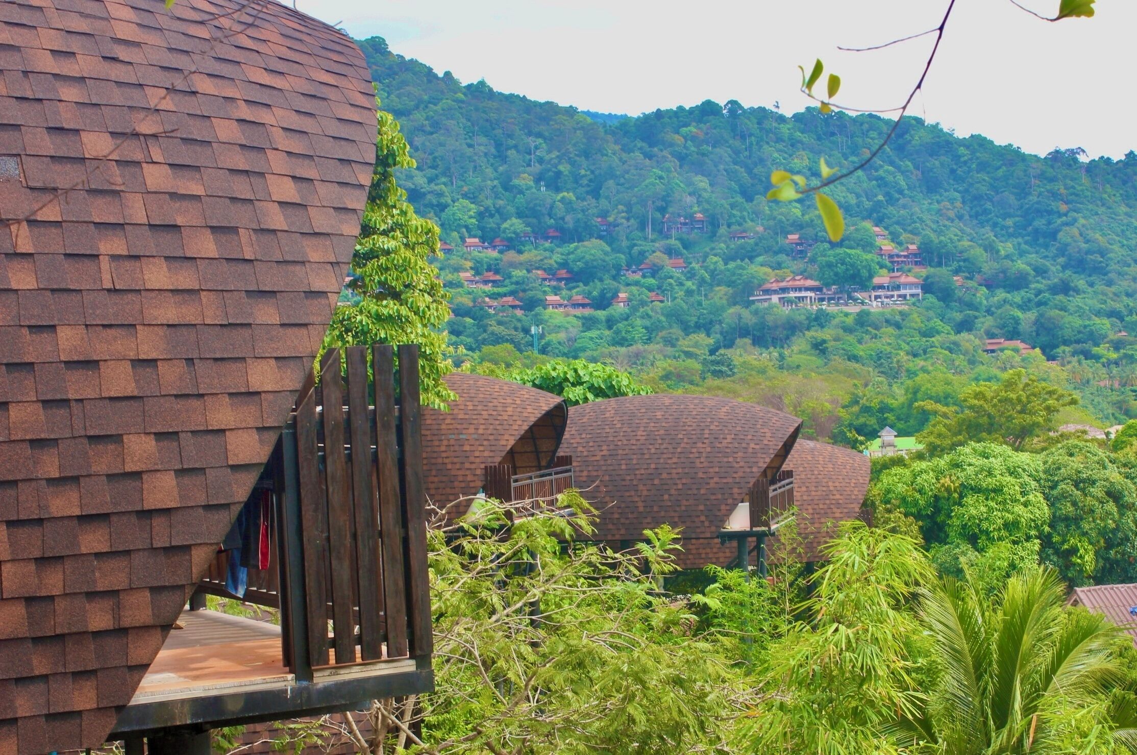A cluster of dome-shaped buildings with a wooden deck in the foreground.