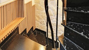 A spiral staircase with black railings and a stone wall. - Stunning Studio for 2 People - Sentier (Paris)