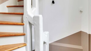 A staircase with wooden steps and white walls. - Chic Studio A/C - 2P - Le Marais (Paris)