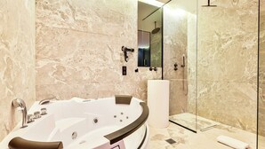 A modern bathroom with a freestanding bathtub, a glass shower enclosure, and marble walls. - Wonderful Private Room - 2P - Chatelet (Paris)