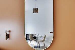 A modern dining area with a round table, two chairs, and a hanging light fixture. - Magnificent Studio - 2P - Near Bastille (Paris)