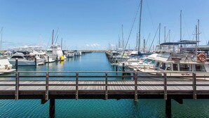 A marina with multiple boats docked at wooden piers. - This apartment is a 2 bedroom(s), 2 bathrooms, located in Fremantle, WA. (Fremantle)