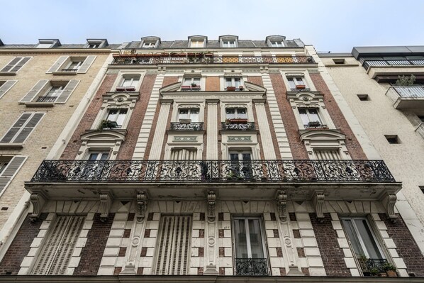 A multi-story building with a classical architectural style, featuring ornate balconies and decorative window frames. - Cosy and Peaceful Studio - 2P - Nation/voltaire (Paris)