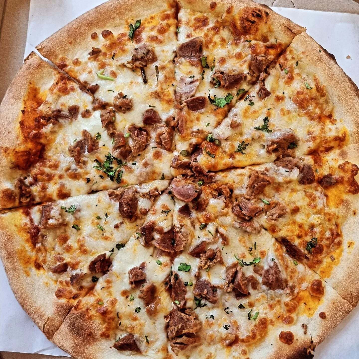 A pizza with toppings.