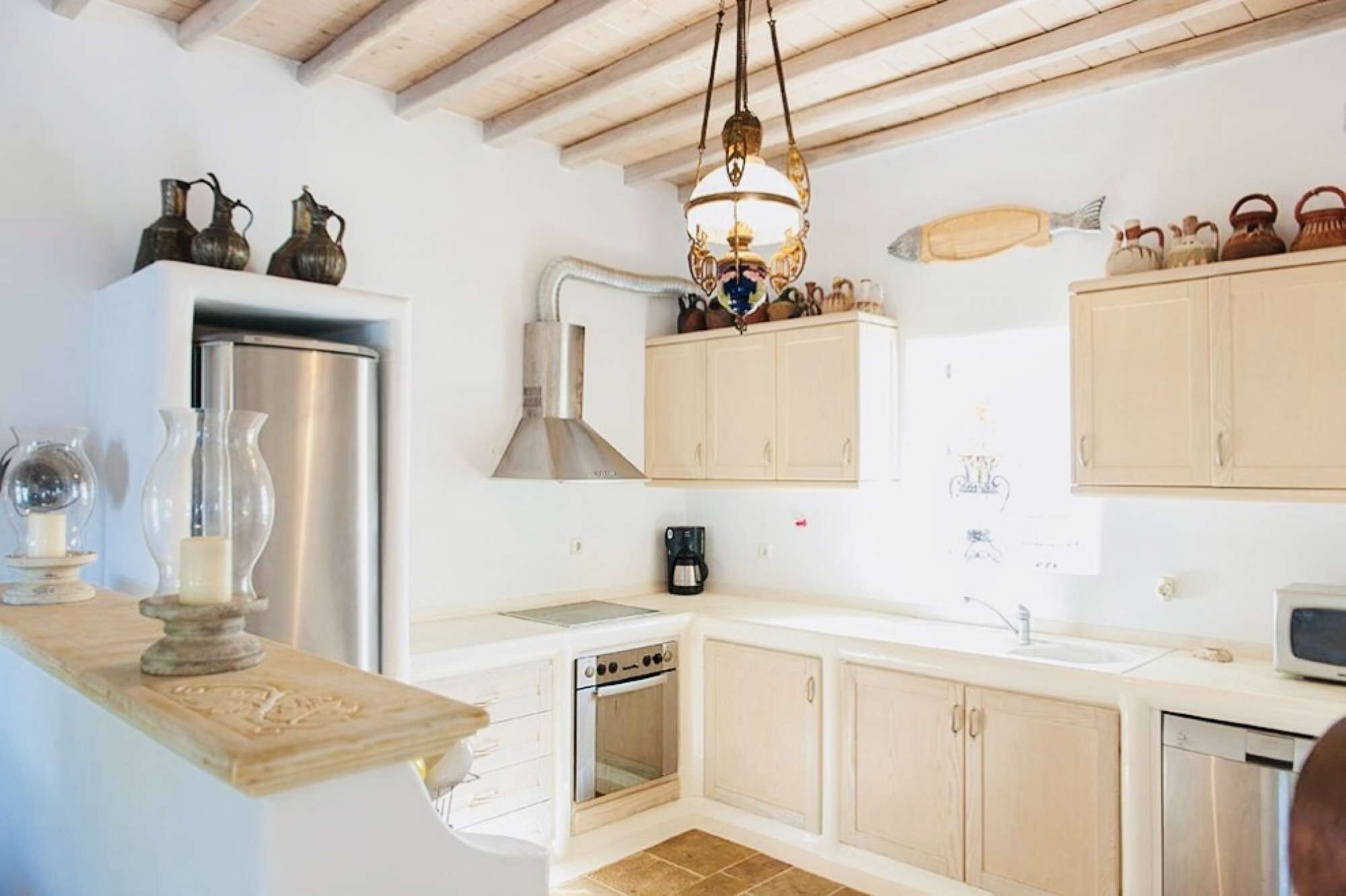 A compact kitchen with a built-in oven, a coffee maker, and a microwave.