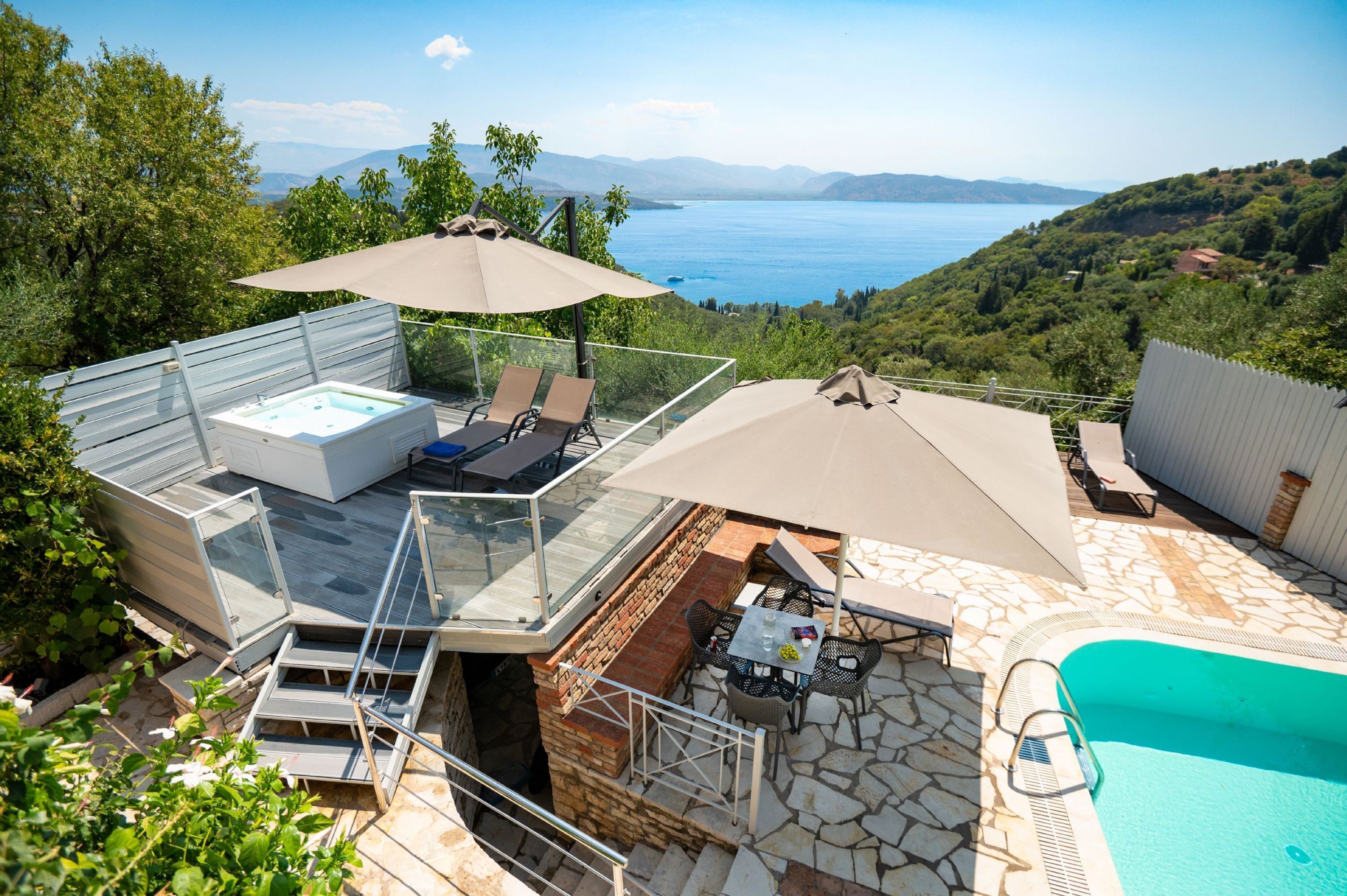 A rooftop terrace with a hot tub, outdoor seating, and a swimming pool.