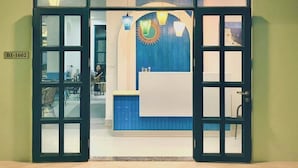 The entrance to The Costi's Hostel-Homestay with a neon sign, a reception desk, and a view of the interior. - The Costis Homestay & Hotel  (Phu Quoc)