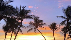 A beach with palm trees and a sunset. - The Costis Homestay & Hotel  (Phu Quoc)