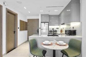 Enjoy a spacious room with a central island, kitchen, and comfortable seating area.
