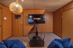 Deluxe huis, balkon | Woonruimte | Een 50-inch flatscreentelevisie met kabelzenders