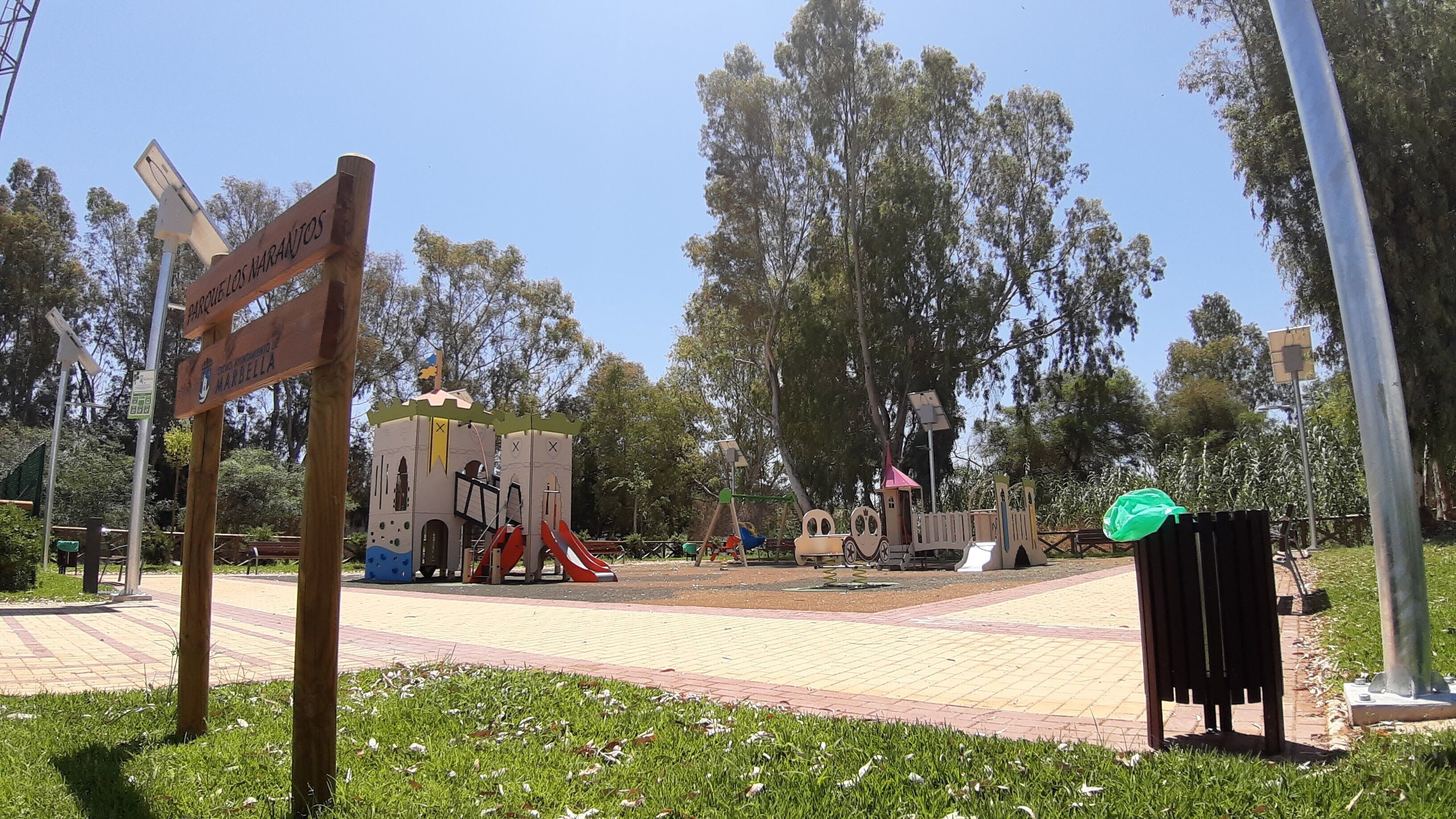 A playground with a castle-like structure, a slide, and a swing set.