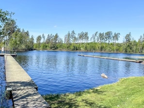 A calm lake with a wooden dock extending into the water, surrounded by dense trees. - 4 Star Holiday Home in Karlskrona (Eringsboda)
