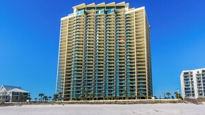 A high-rise hotel with multiple balconies, located near a beach. - Phoenix West 1506 (Orange Beach)