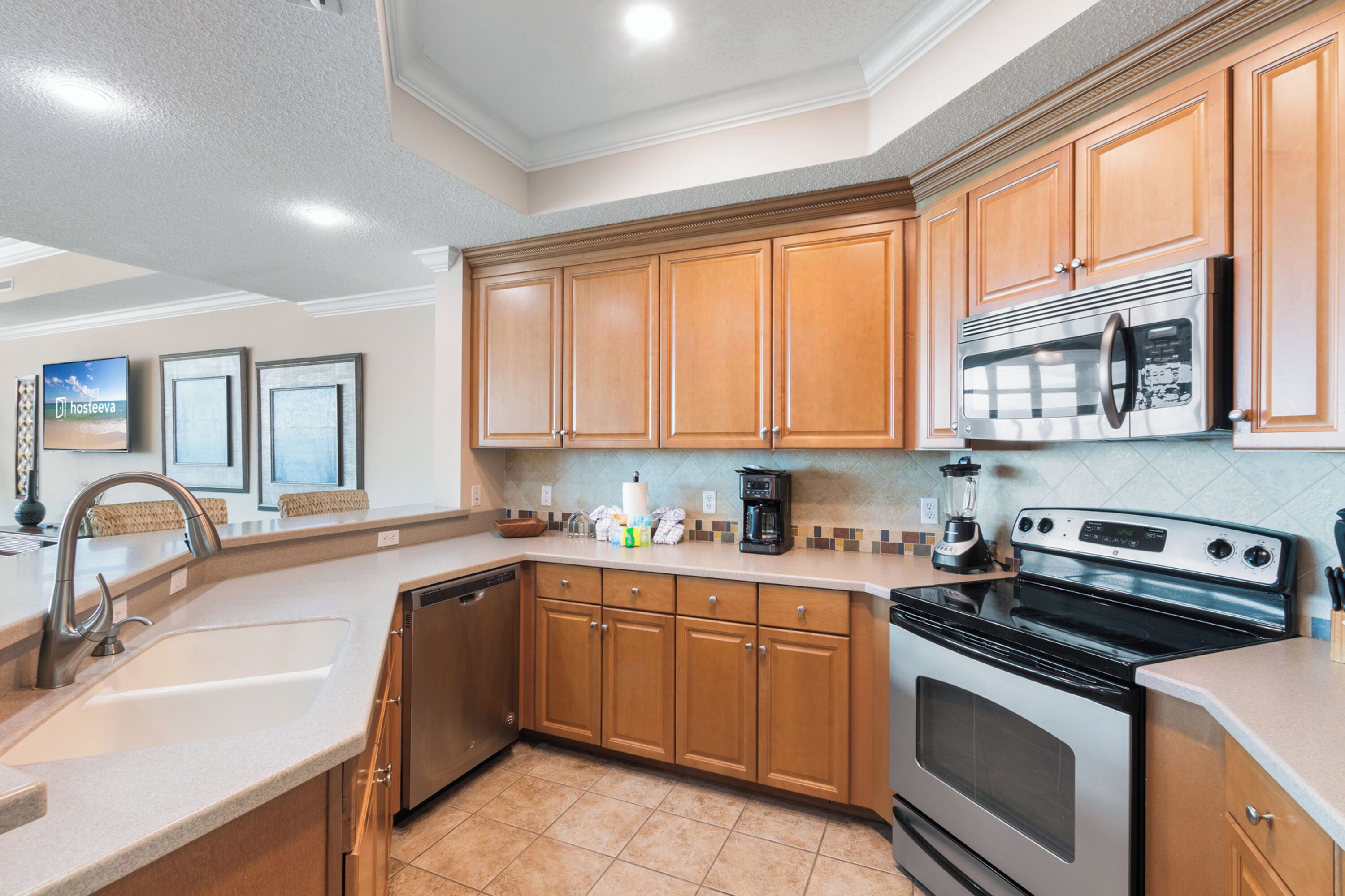A modern kitchen with wooden cabinets, stainless steel appliances, and a tiled backsplash.