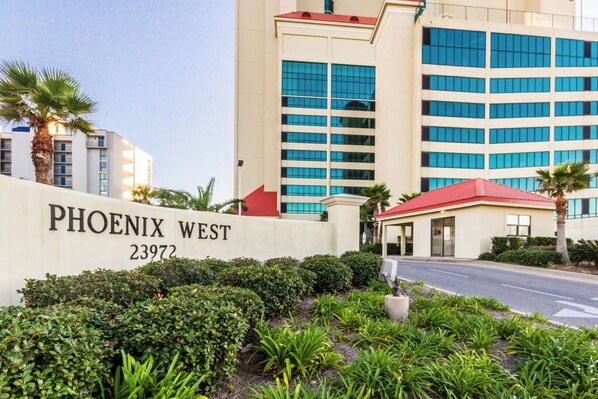 A hotel entrance with a sign reading "PHOENIX WEST 23972". - Phoenix West 1506 (Orange Beach)