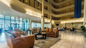 A spacious lobby with leather sofas, a coffee table, and a large rug. - Phoenix West 1506 (Orange Beach)