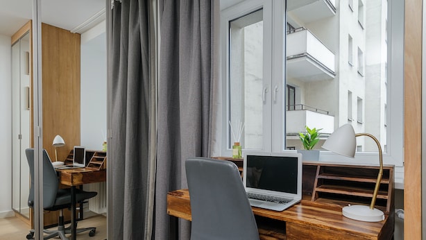 A modern office space with a wooden desk, a laptop, a chair, and a lamp. - Lumina apartment in center Warsaw (Warsaw)