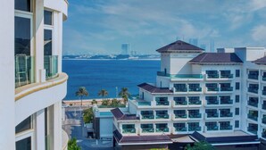 A multi-story hotel with balconies overlooking a beach and ocean. - GLOBALSTAY. Azizi Royal Bay Apartments (Dubai)